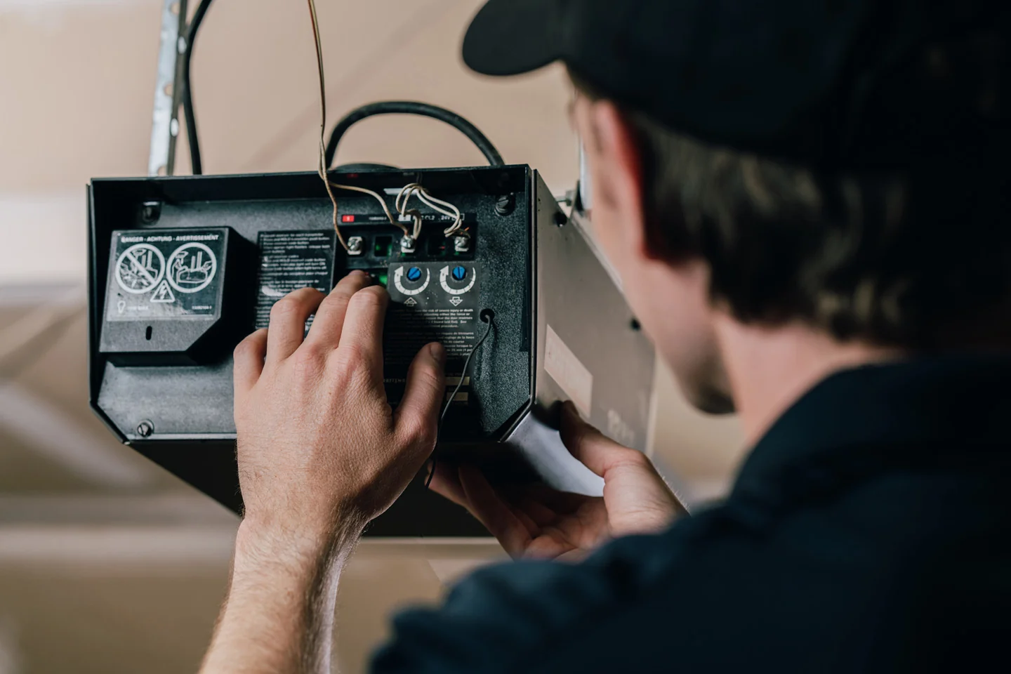 Precision Garage Door technician fixing a garage door opener Precision Garage Door technician fixing a garage door opener